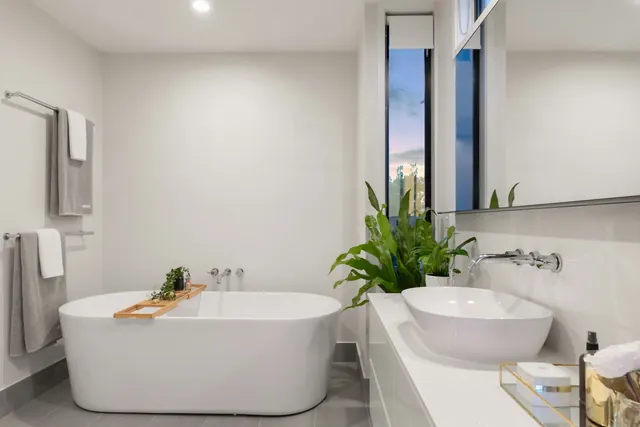 Clean, bright bathroom with a freestanding tub and polished vanity