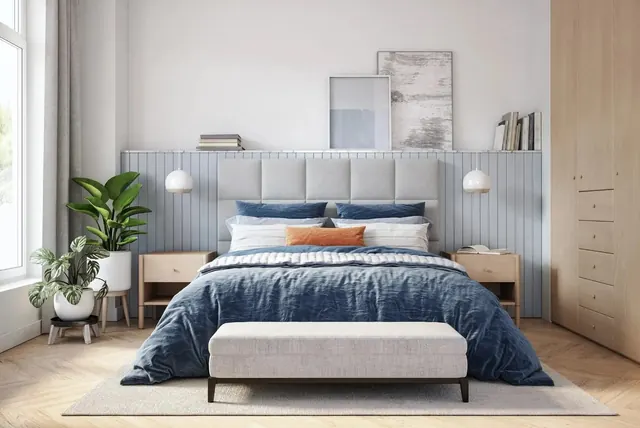 Neatly made bed in a calm, tidy bedroom