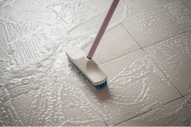 Scrubbing tile floors with soapy water