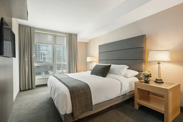Hotel style bed with crisp white linens in a vacation rental